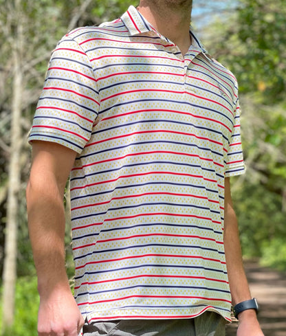 Introducing our New Orleans Flag Men's Performance Polo, a pinnacle of style and functionality designed to elevate your active lifestyle. Immerse yourself in the spirit of the vibrant New Orleans theme that sets this polo apart. Don the colors and famous fleurs-de-lis of the city you can't help but love! Model: Ray Clement